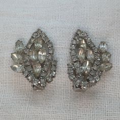 We love the size of these vintage rhinestone statement earrings. The 1950s retro earrings are made in a large paisley shape and sit approximately 1.5" tall x 1" wide. They are well-made with prong-set rhinestones and clip on backs. Vintage Jeweled Clip-on Earrings For Evening, Vintage Silver Earrings For Wedding, Antique Silver Clip-on Earrings For Wedding, Vintage Pear-shaped Earrings For Formal Occasions, Vintage Pear-shaped Formal Earrings, Vintage Silver Wedding Earrings, Vintage Jeweled Clip-on Earrings For Party, Vintage Silver Jeweled Clip-on Earrings, Vintage Silver Crystal Earrings For Wedding