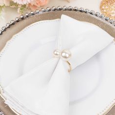 a white plate topped with a napkin covered in pearls