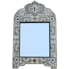 an ornate mirror is shown against a white background