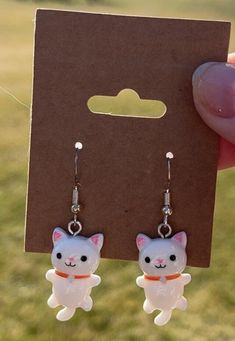 - Cute white cat earrings - Nickle free - Silver ear wire closure Feel free to message me any questions! Cute White Drop Earrings, Cute White Jewelry With Ear Wire, White Novelty Dangle Jewelry, Novelty White Dangle Jewelry, Handmade White Kawaii Jewelry, White Handmade Kawaii Jewelry, Novelty White Hypoallergenic Jewelry, Novelty Hypoallergenic White Jewelry, Hypoallergenic Novelty White Jewelry