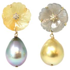 A one-of-a-kind dangling Earrings featuring natural sapphire flower carvings and south sea pearls. The sapphire flowers are reverso yellow and grey with South Sea Tahitian grey and South Sea golden pearl drop pendants. The earrings are set in 18-karat yellow gold with a flower diamond accent. The baroque pearls are 11-12 millimeters with very good luster and minor surface inclusions. The gross weight is 9.7 grams. The earrings are 1.33” long. Pearl Drop Pendant, Golden Pearl, Cool Earrings, Flower Dangle Earrings, Pearls Earrings, Flower Carving, Baroque Pearl Earrings, South Sea Pearls, Sea Pearls