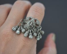 Substantial old tribal high grade silver  ring from Rajasthan. Three bunches of bell tassels are  attached to the ornate silver band. For more info & purchase check cosmicnorbu.com Measurements are: Size: 8.5 Weight: 14gr. This ring ships registered priority and with tracking ❀ Please read my shop and return policies before purchasing ❀ https://www.etsy.com/shop/CosmicNorbu/policy?ref=shopinfo_policies_leftnav Traditional Antique Silver Ring Jewelry, Traditional Antique Silver Ring, Traditional Silver Metal Rings, Traditional Silver Jewelry With Bells, Rajasthani Jewelry, Indian Rings, Jewelry Indian, Silver Band, Rings Statement