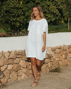 "Oversized linen T-shirt dress MIJAS in white is the epitome of comfort. Inspired by the silhouette of boyfriend's T-Shirt it brings to life the concept of looking good & feeling good. Linen fabric allows your skin to breathe, therefore you will feel fresh on warm days. The style of this linen dress is so versatile that you can keep reinventing your looks. Wear this dress on its own with sneakers or sandals, or pair it with wide linen pants or longer shorts - you will be surprised how easy it is Oversized Casual Linen Beach Dress, Oversized Casual Linen Dress For Beach, Oversized White Linen Casual Dress, Casual Oversized White Linen Dress, Casual Beach Linen Tunic Dress, Casual Linen Tunic Dress For Vacation, Casual Linen Tunic Dress For Beach, White Relaxed Fit Dress For Loungewear, White Relaxed Fit Linen Dress