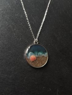 This beautiful necklace is a wonderful idea for gift giving and as a little gift for yourself. The pendant measures approximately 3 cm. Please choose your chain length preference in the drop down box. See more jewellery here: https://www.etsy.com/shop/simplysweetjewellery I'm happy to help you find what you're looking for! Please feel free to message me with any questions. Thank you for shopping at Simply Sweet Jewellery! PLEASE NOTE: Colours may not look the same as on your computer - Avoid any Scene Necklace, Necklace Resin, Sweet Jewelry, Beach Scene, Sea Beach, Circle Shape, Beach Scenes, Beautiful Necklace, I'm Happy