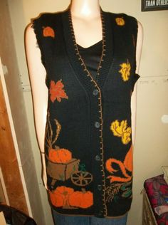 Up for auction today is a vintage JJ Poole sweater vest.  Medium. New.  Acrylic.  Made in USA.  Has pumpkins in a wheelbarrow with wheat.   Chest:  23 inches across.   Shoulder to hem:  29 inches. Black Sweater Vest, Large Pumpkins, Autumn Pumpkins, Fall Vest, Cardigan Sweater Vest, Halloween Sweater, Button Sweater, Vest Outfits, Black Sweater