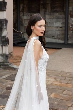 a woman in a wedding dress with a long veil