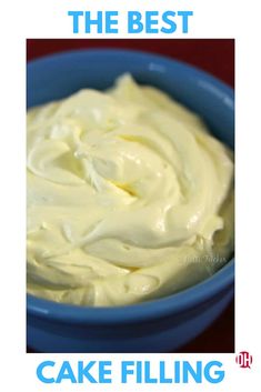 a blue bowl filled with cream on top of a red table