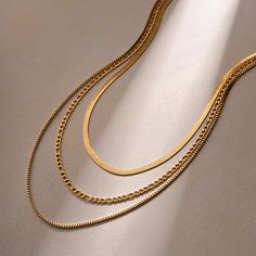 Discover Timeless Elegance with Our 18K Gold Plated Flat Snake Chain Necklace Elevate your style with our exquisite 18K Gold Plated Stainless Steel Flat Snake Chain With Letter Triple Layered Necklace. Crafted to perfection, this necklace blends vintage luxury with modern sophistication, making it a must-have accessory for every fashion-forward woman. Product Features: 18K PVD gold plating for long-lasting color and anti-scratch resistance Waterproof stainless steel material for durability Nickel, lead, and cadmium-free for skin-friendly wear Tarnish-proof design for lasting beauty Triple layered chain with flat snake chain and letter charms for a unique look Perfect for parties, anniversaries, weddings, and everyday elegance Benefits of Our Necklace: Timeless Elegance: The classic design Elegant Gold Double Chain Necklace, Gold Snake Chain Necklace For Wedding, Classic Gold Double Chain Necklace, Elegant Gold Necklace With Figaro Chain, Timeless Gold Double Chain Necklace, Gold Figaro Chain Necklace For Wedding, Vintage Tarnish Resistant Necklace For Formal Occasions, Vintage Tarnish-resistant Necklace For Formal Occasions, Vintage Formal Tarnish-resistant Necklace