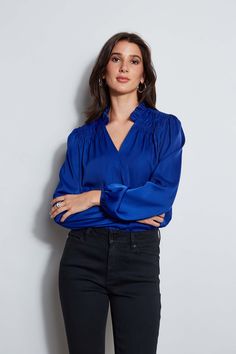 It's all in the details. Romantic & feminine, our smocked long sleeve shirt features a split tie neckline & pleated ruffle stand collar. With its long blouson sleeves & effortless fit, this style is a year-round essential. T-Tahari Long sleeve Airflow Blouse with Smocking Detail Runs true to size Model is 5'9" and wearing size S 100% Poly Georgette Dry Clean Only Imported Style #: THF47006 Chic V-neck Smocked Top With Blouson Sleeves, Elegant Smocked Bodice Blouse For Brunch, Elegant Blouse With Smocked Bodice For Brunch, Chic Blouse With Smocked Cuffs For Brunch, Elegant Smocked Top For Brunch, Chic Ruffled Split Neck Blouse, Chic Split Neck Blouse With Ruffles, Elegant Smocked Top With Gathered Sleeves For Brunch, Chic Smocked Top With Ruffled Collar