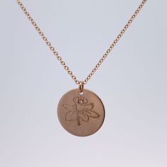 Celebrate their birthday with this dazzling Diamond Birth Flower Necklace. Each necklace features a stunning diamond and a unique birth flower charm, making it a perfect personalized gift. Show them how much you care (and know them) with this gorgeous and meaningful piece. Materials: 14k Gold Fill | 14k Rose Gold Fill | Sterling Silver Measurements: 16" chain, 18" chain Pendant: 5/8" coin Elegant Birthstone Medallion Charm Necklace, Elegant Medallion Charm Necklace With Birthstone, Rose Gold Birth Flower Pendant Necklace, Elegant Flower Charm Necklace With Birth Flower, Rose Gold Flower Pendant Necklace With Birth Flower, Rose Gold Engraved Flower Pendant Necklace, Elegant Flower Shaped Birth Flower Charm Necklace, Engraved Rose Gold Necklace With Flower Pendant, Elegant Birth Flower Pendant Charm Necklace