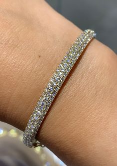 Bangles are great for stacking, but with this bold and beautiful diamond bangle bracelet, you only need one! This 18K yellow gold bracelet is simply covered in pave round diamonds...sparkle all the time with this beautiful bangle!Metal: 18K Yellow GoldDiamond Weight: 2.87ct twDiamond Shape: 109 Round Brilliant CutsBangle/Wrist Width: 46 x 56mmBangle Height: 5mm Estimated production time is 4 - 5 weeks. Diamond And Gold Bangles, Diamond Bangle Bracelet, Diamond Bangles Bracelet, Diamonds And Gold, Diamond Bangle, Bold And Beautiful, Yellow Gold Bracelet, Hand Jewelry, Gold Bangles