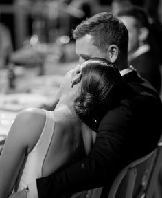 a man and woman sitting next to each other on a bench