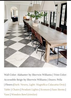 a dining room table with chairs and lights hanging from it's center beam, in front of a checkerboard floor