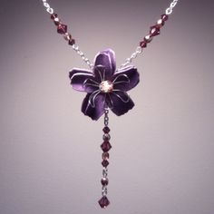 Simple, Yet Bold. This Beautiful Floral Necklace Has A Feminine Style And Flattering Shape. Made With Purple Swarovski Crystals And Gold Czech Glass Beads. Measures 16 Inches With A 2.5 Inch Extender Chain. The Drop Measures 2.5 Inches. The Length Can Easily Be Adjusted, And The Extender Chain Can Be Removed If Desired. Item May Vary Slightly From The One Pictured. Not Intended For Children Under 12. Violet Flower Necklace, Lily Necklace, Purple Lily, Violet Flower, Floral Necklace, Flower Necklace, Czech Glass Beads, Purple Gold, Feminine Style