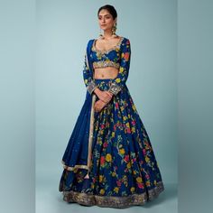 This Beautiful Peacock Blue Lehenga Is Made Of Pure Banarasi Soft Silk Material And The Blouse Has Detailed Golden Handwork Which Gives It An Extraordinary Touch. Traditional Blue Floral Print Lehenga, Traditional Blue Lehenga With Floral Print, Blue Bollywood Lehenga With Floral Print, Blue Floral Print Choli For Festive Occasions, Festive Blue Floral Print Choli, Blue Floral Print Wedding Sets, Blue Silk Choli With Floral Embroidery, Peacock Blue Lehenga, Blue Lehenga