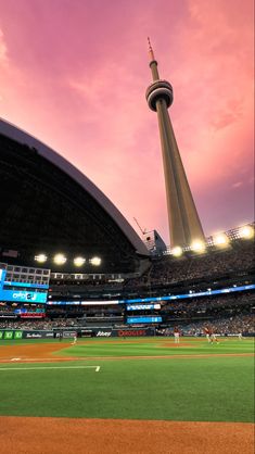 a baseball field with the sky in the background and some lights on top of it