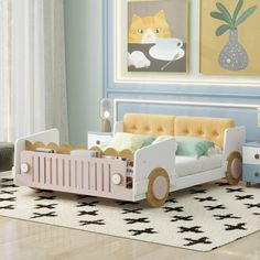 a child's bedroom with a toy car bed and toys on the floor in front of it