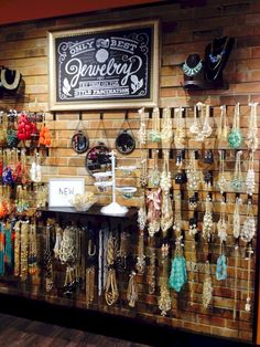 an image of a store display with jewelry on the wall and in front of it