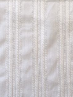 closeup of white fabric with vertical stripes