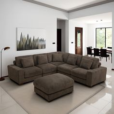 a large sectional couch sitting in the middle of a living room