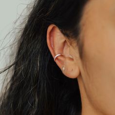 Rejoice! No piercings required to achieve the multiple-piercing look! This comfy ear cuff is easy to put on, adjustable to your ear shape, and looks so dang cute! The Nova Ear Cuff uses a thick half-round wire, making it slightly chunkier than our other ear cuffs. The Nova Ear Cuff is paired with our Classic Ear Cuff in the third photo and Double Ear Cuff in the fourth photo. Details: Two size options: 8 or 10mm depending on your ear size and where you want to wear the cuff Typically, we suggest Adjustable Single Ear Cuff For Everyday Wear, Trendy Hypoallergenic Ear Cuff For Everyday Wear, Minimalist Pierced Adjustable Ear Cuff, Minimalist Adjustable Pierced Ear Cuff, Trendy Adjustable Pierced Ear Climbers, Adjustable Trendy Ear Climbers, Adjustable Hypoallergenic Sterling Silver Ear Cuff, Adjustable Hypoallergenic Ear Cuff For Everyday Wear, Hypoallergenic Adjustable Ear Cuff For Everyday