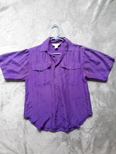 "100% washable silk camp shirt from Casual Corner. Color is more intense and to the red side of purple than photos show. Pic showing care tag is truer to color. Wear alone or layer with tank top. Buttons down center and on front pockets, short sleeves. Great condition; no tears or holes. Couple fade spots underarm seam. Tag states Medium, however it runs small. Measurements are taken flat and double where appropriate: Bust 40\" (taken from underarm seam, across shirt, to opposite seam) Arm openi Vincent Rebornica, Dark Purple Shirt, Tomboy Shirts, Purple Clothing, Royal Purple Color, Concert Fit, Orange Outfit, Concert Outfits, Purple Outfits