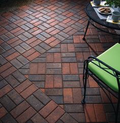 a table and chair sitting on top of a brick patio