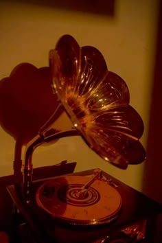 an old record player is sitting on top of a table with a heart shaped object above it