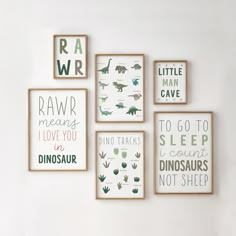 a set of four framed dinosaur prints on the wall above a bed in a child's bedroom