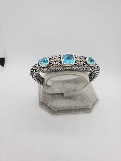 You are viewing a beautiful heavy and thick sterling silver / 18k blue topaz bracelet. The bracelet measures 7 5/8 inches long The bracelet is heavy and very well made with women design. The bracelet is 10mm wide . The total gram weight of the bracelet is 92.69 grams Signed : BJC MARKED : 925 / 18K The workmanship of the bracelet is extraordinary,good condition.. Please make sure to measure your wrist if it fits before buying it. If you have a question please send me a message Samuel B. is a fin Western Style Blue Sterling Silver Bracelet Collectible, Hallmarked Blue Sterling Silver Bracelet, Nickel-free Blue Dangle Bracelets, Blue Hand-set Cubic Zirconia Bracelet, Modernist Hallmarked Sterling Silver Bracelets, Topaz Bracelet, Women Design, Blue Topaz Bracelet, Cabochon Ring