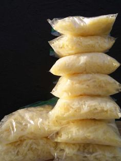 a pile of food sitting on top of a wooden table next to a black wall