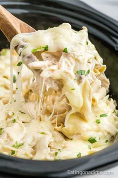 the crock pot is filled with creamy chicken and noodle casserole, ready to be eaten