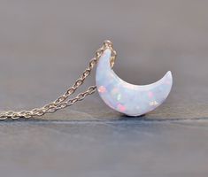 "A sweet new necklace made using a lab created opal moon charm. I love these little charms! They are crescent shaped and drilled near the top. It hangs from either 14K gold filled or Sterling silver chain (shown in gold filled in all photos above, but you can order in sterling silver at checkout). Moon measures 11mm (1/2\") and chain is a dainty 1 mm thick. Please choose desired color of moon and chain finish/length at checkout. Listing is for ONE necklace, in color and metal of choice. ** PLEAS White Sterling Silver Necklace With Moon Charm, Celestial White Opal Jewelry, White Dainty Jewelry With Moon Charm, Dainty White Moon Phase Jewelry, Dainty White Moon-shaped Jewelry, Dainty White Crescent Necklace, White Half Moon Jewelry For Gift, Opal Moon Necklace, Crescent Shape