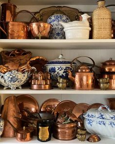 shelves filled with pots and pans on top of each other