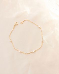 Pearl bracelet, Pearl charm bracelet, Dainty gold bracelet, Tiny pearl bracelet, Minimal bracelet, Delicate pearl bracelet, Simple bracelet --- Give your look a timeless, sophisticated edge with the Ella Bracelet! This classic beauty features a string of pearls that wrap all the way around, making it the perfect accessory for any bridal or special occasion. Feel your most elegant wearing a piece that'll never go out of style! Details: -Gold Filled, Sterling Silver -2mm pearl size  -Waterproof, T Delicate Gold Chain Bracelet With Pearls, Dainty Gold Bracelets With Pearl Chain, Dainty Gold Pearl Bracelet With Pearl Charm, Dainty Gold Chain Bracelet With Pearl Charm, Dainty 14k Gold-filled Pearl Bracelet, Delicate 14k Gold Filled Pearl Bracelet, Dainty Gold Pearl Chain Bracelet, Delicate Gold Chain Bracelet With Pearl Charm, Dainty Pearl Charm Chain Bracelet