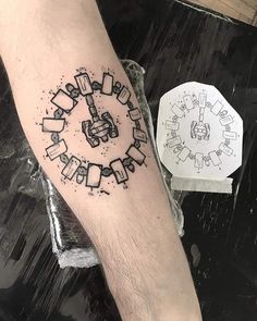 a man with a tattoo on his arm that has an image of a train in the middle