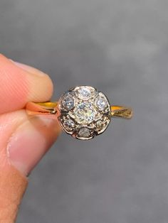 someone is holding an old diamond ring in their hand