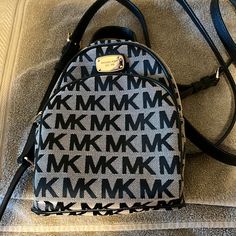 This Is A Beautiful Unused Mk Mini Backpack Black And Tan Brass Color Hardware Was A Gift And It’s Just Been In My Closet It Needs Someone To Love It Smoke Free Home Michael Kors Black Standard Backpack, Michael Kors Black Travel Backpack, Michael Kors Black Backpack For Daily Use, Michael Kors Black Backpack For Travel, Michael Kors Mini Backpack, Monogram Backpack, Mini Backpack Purse, Michael Kors Backpack, Bags Michael Kors