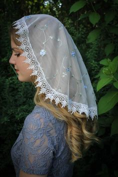 "A delicate, feminine, and reverent veil for worship. This is SOFT! This is a new take on an older style; a one piece princess veil, that falls nicely, and has a sewn-in clip to keep it in place. High quality embroidered ivory/Marian blue rose floral lace, trimmed in an elegant white Venise trim. It comes with our free veil storage bag! Please convo us with any questions or special requests! Also in \"D\" shape: https://www.etsy.com/listing/504196111/evintage-veilsst-therese-little-flower?ref=sh One Piece Princess, Princess Veil, Chapel Veil Catholic, Catholic Veil, Lace Mantilla, Beautiful Veil, Chapel Veil, Roman Goddess, St Therese