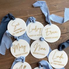 six personalized bridesmaid or groomsmid gift tags with satin ribbons and blue ribbon