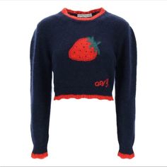 a cropped sweater with an embroidered strawberry on it