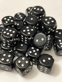 a pile of black and white dice sitting on top of each other