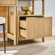 a wooden desk with a gold bowl on top