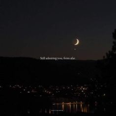 the moon is shining in the night sky over some water and trees, with an inspirational quote written below it