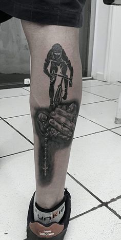 a man with a bike tattoo on his leg