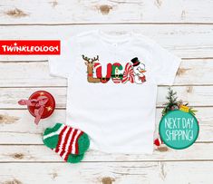 "Personalized Christmas Kids Shirt - Cute Christmas Name Toddler Shirt - Personalized Custom Name Toddler Shirt - Custom Christmas Shirt If you're like us and love your kid looking cute all the time, then this super soft, Christmas Shirt is going to make your day! Designed with stylish mamas in mind. **Sizing Tip** Shirts are designed on 100% Cotton. They tend to run true to size. They have a ribbed collar, double needle stitched and bottom hemmed. HOW TO ORDER: 1. Choose the quantity you would like to purchase. 2. Enter any specific notes you would like seller to know in the \"Note to Seller\" section. 3. Click \"Add to cart\". For multiple items go back to the listings and repeat the same steps /DETAILS - 100% Cotton - Machine Washable - Short Sleeve - 100% Handmade in the USA /CARE INST Christmas Shirts Vinyl, Kids Christmas T Shirts, Soft Christmas, Christmas Shirts For Kids, Christmas Names, Christmas Kids, Kids Graphic Tees, Iron On Vinyl, Cute Christmas