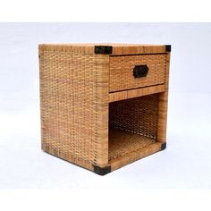 a wicker side table with two drawers on one end and an open drawer on the other