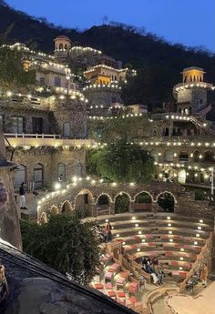 an outdoor seating area is lit up at night