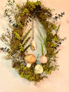 a wreath made out of moss and shells