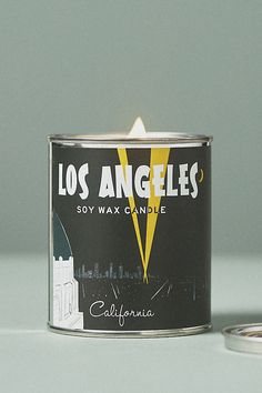 a candle that is sitting on a table next to a can with the words los angeles written on it